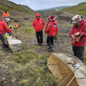 Drilling holes ready for rock splitting demos.